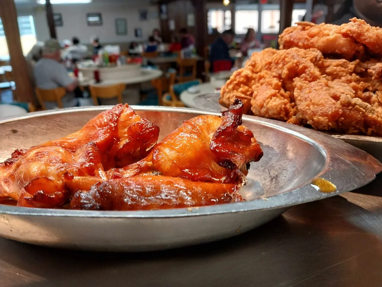 Golden fried chicken and BBQ wings in Bea's metal serving dishes